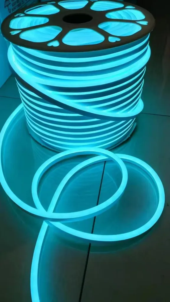 A spool of glowing blue LED silicone neon flex with smooth, flexible tubing coiled in a neat stack, designed for architectural and commercial lighting.