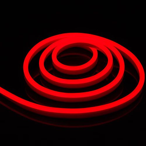 Coiled red silicone neon flex light emitting vibrant glow on a dark background.