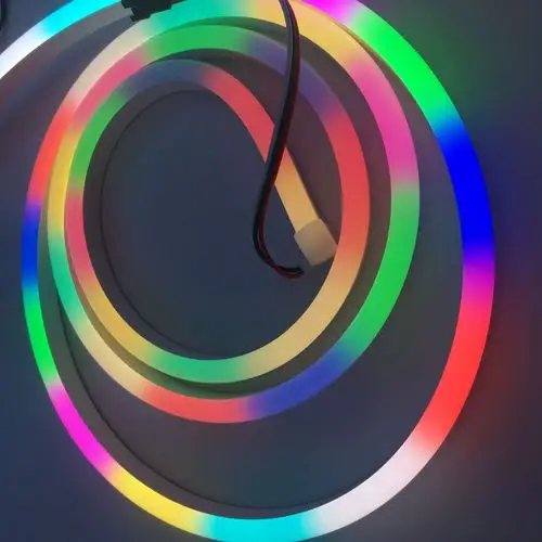 Flexible silicone neon flex light emitting vibrant RGB colors, coiled in a circular layout on a dark background.