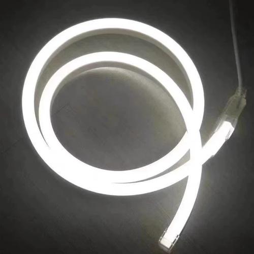 Coiled flexible silicone neon flex LED light glowing with bright white illumination against a dark background.